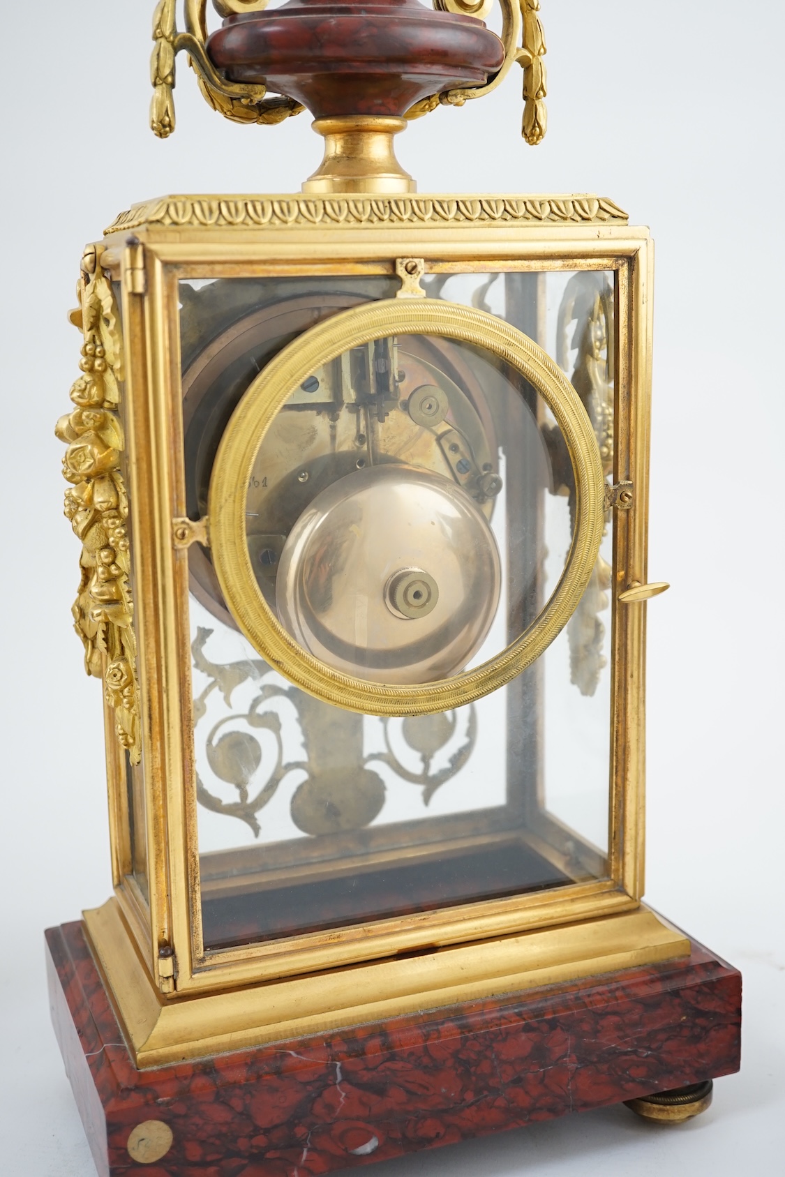 Revel à Paris. A 19th century French ormolu and rouge marble clock garniture